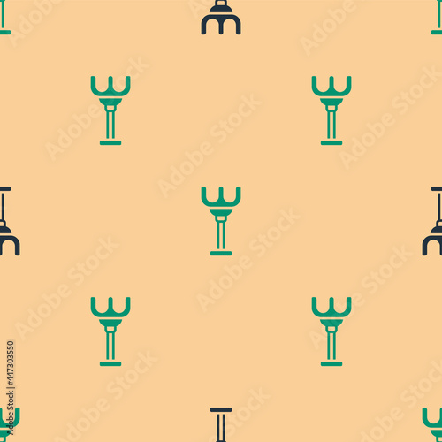 Green and black Rake toy icon isolated seamless pattern on beige background. Children toy for beach games. Vector