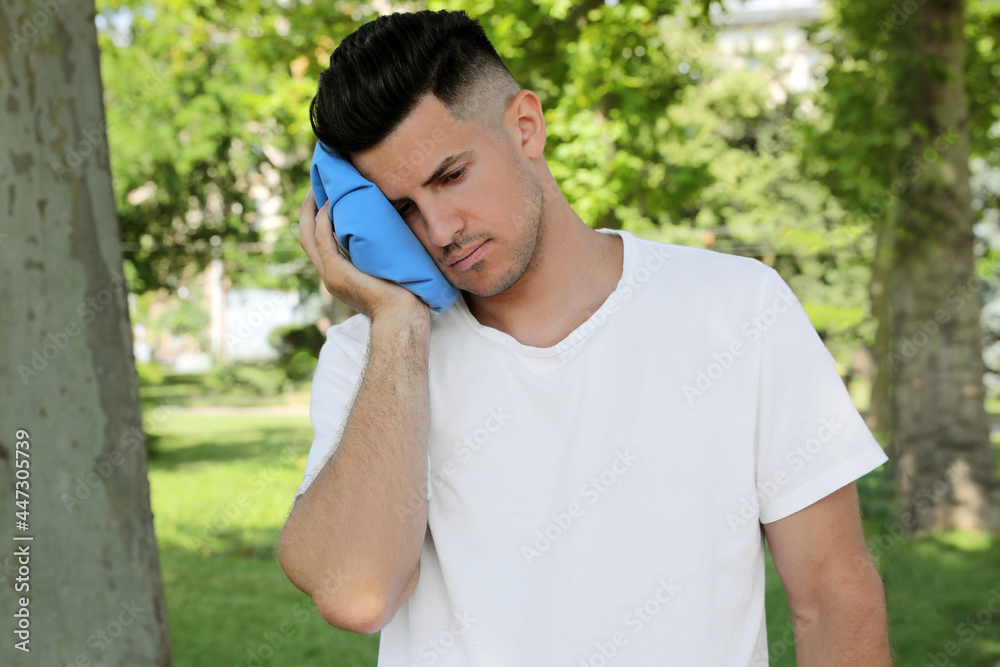 Man with cold pack suffering from heat stroke outdoors Man with cold pack suffering from heat stroke outdoors