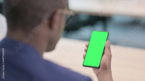 Young African Businessman Using Smartphone with Green Chroma Screen