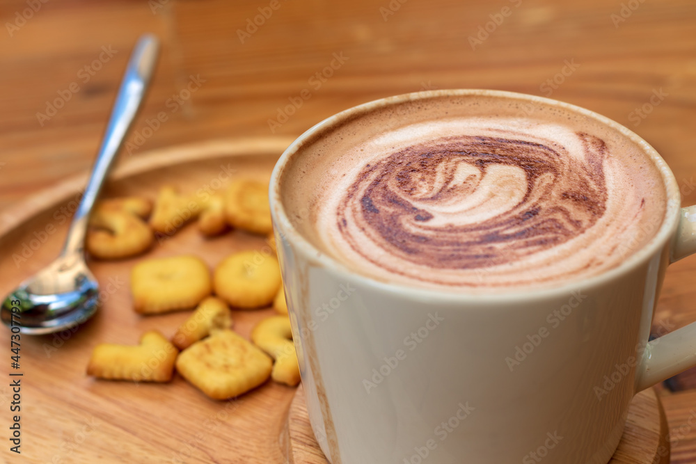 Cup of coffee and biscuit on wooden plate. Drink fresh daily. Cup of coffee and biscuit on wooden plate. Drink fresh daily.