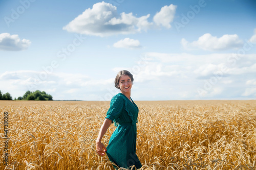Girl in   dress walking through   field of wheat © DariaTrofimova