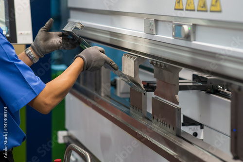 Bild auf Leinwand The technician operator working with hydraulic press brake bending machine