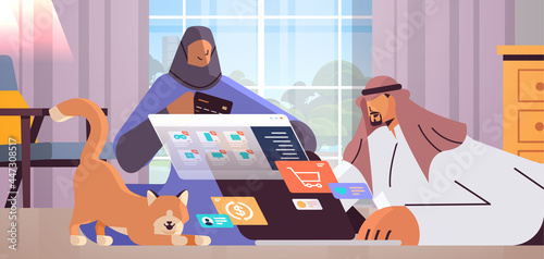 arab couple with credit card using laptop online shopping concept man woman ordering goods together