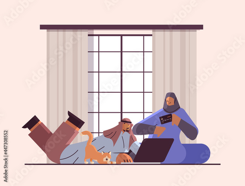 arab couple with credit card using laptop online shopping concept man woman ordering goods together