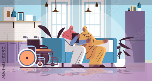 friendly nurse or volunteer supporting arab elderly woman home care services healthcare and social support concept