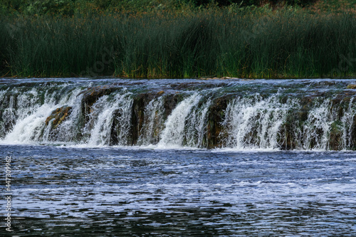 low and wide waterfall on the river