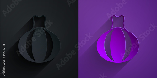 Paper cut Onion icon isolated on black on purple background. Paper art style. Vector