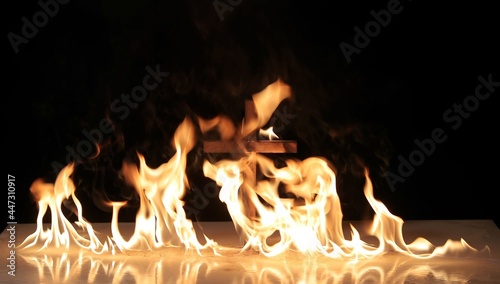 Fotografie Fire around a burning cross symbol