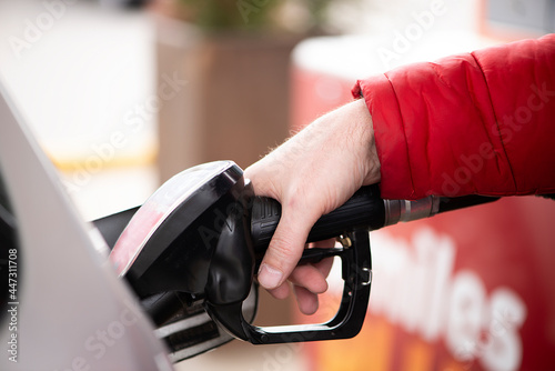 man's hand is refuelling gas or oil in the refuelling station prepare transport to travel