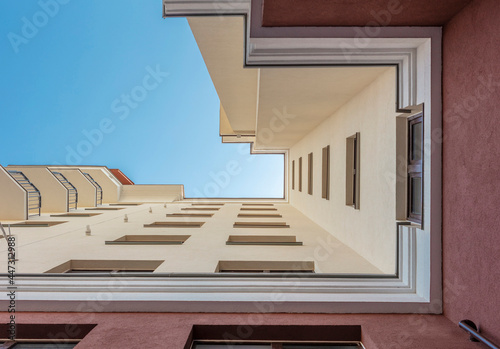 Facade of modern multi-storey building in the city. Bottom view. Space for text. High quality photo