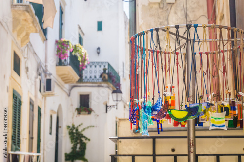 Fototapeta Naklejka Na Ścianę i Meble -  Colorful craft jewellery on sale, local shop in beautiful narrow streets of the old town in Otranto, Italy, Puglia.