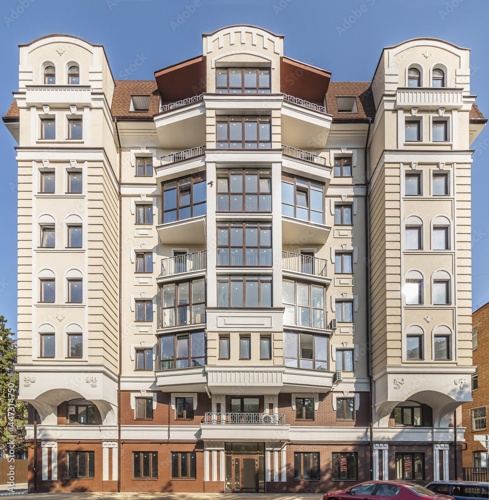 Facade of modern multi-storey brown beige building in the city. Space for text. High quality photo Facade of modern multi-storey brown beige building in the city. Space for text. High quality photo