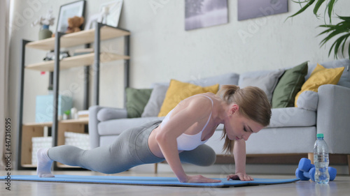Woman doing Crunches Exercise on Yoga Mat