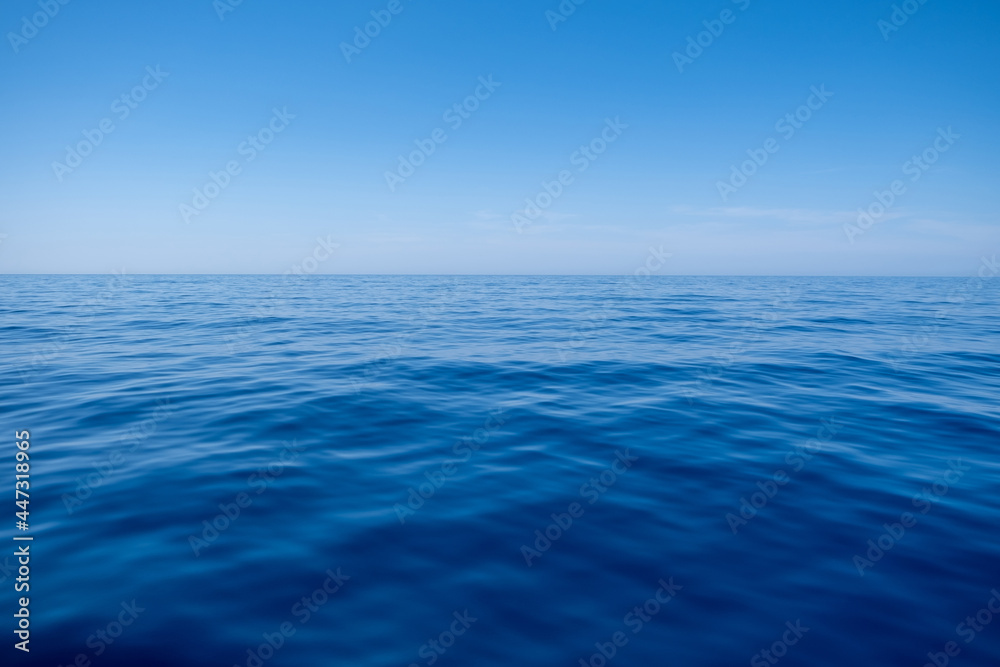 custom made wallpaper toronto digitalSea water surface calm with small ripples, deep blue color and blue sky background,