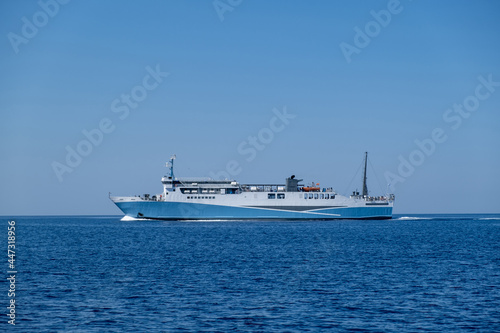 Ferryboat in blue Aegean sea and sky background. Greek island. Greece