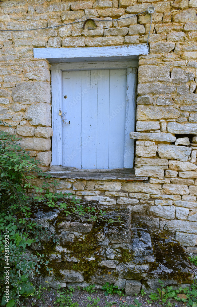 Vintage blue shutter in old wall