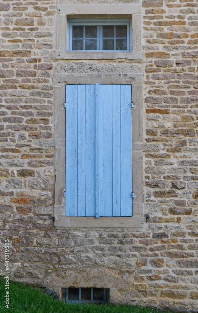 old window with light blue shutters