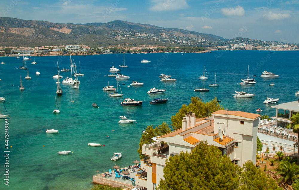 View of the bay with emerald water and yachts in sunny weather, Mediterranean Sea, Mallorca