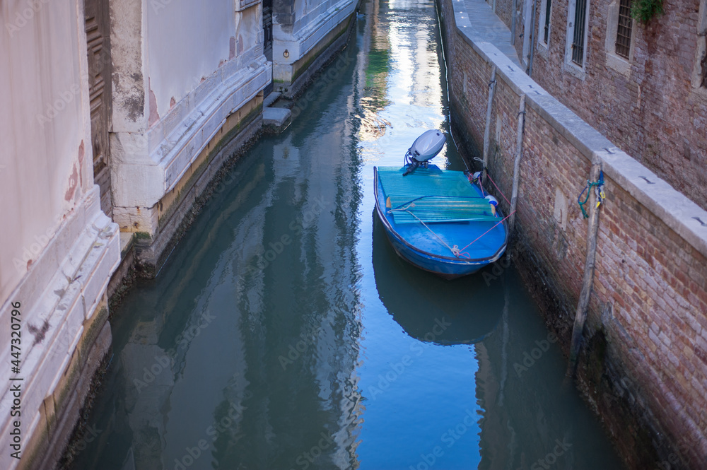 romantic idyllic view of boats moored in  narrow canal of Venice