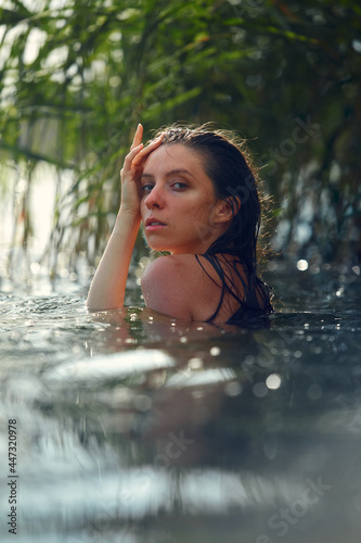 Sensual fasion portrait of woman in the water. Summer emotional  beautiful portrait of a swimming woman resting in the water