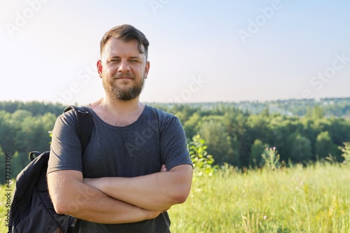 Portrait of confident smiling man with folded arms looking in camera