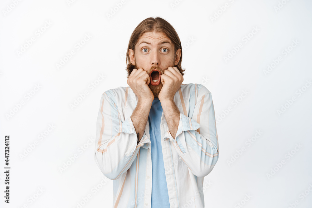 Portrait of surprised bearded blond guy, say wow, gasping and looking excited, watching something amazing, look with impressed face, white background Portrait of surprised bearded blond guy, say wow, gasping and looking excited, watching something amazing, look with impressed face, white background
