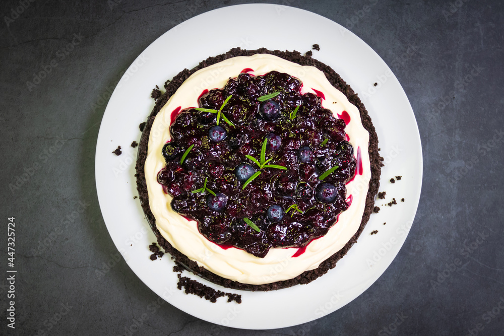 Homemade creamy cheese pie with juicy blueberry sauce and fresh blueberries. Selective focus. Homemade creamy cheese pie with juicy blueberry sauce and fresh blueberries. Selective focus.