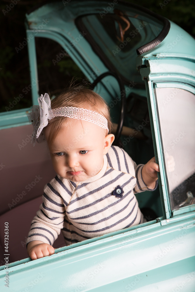 Serious little girl swears at someone while sitting in the car. Serious little girl swears at someone while sitting in the car.