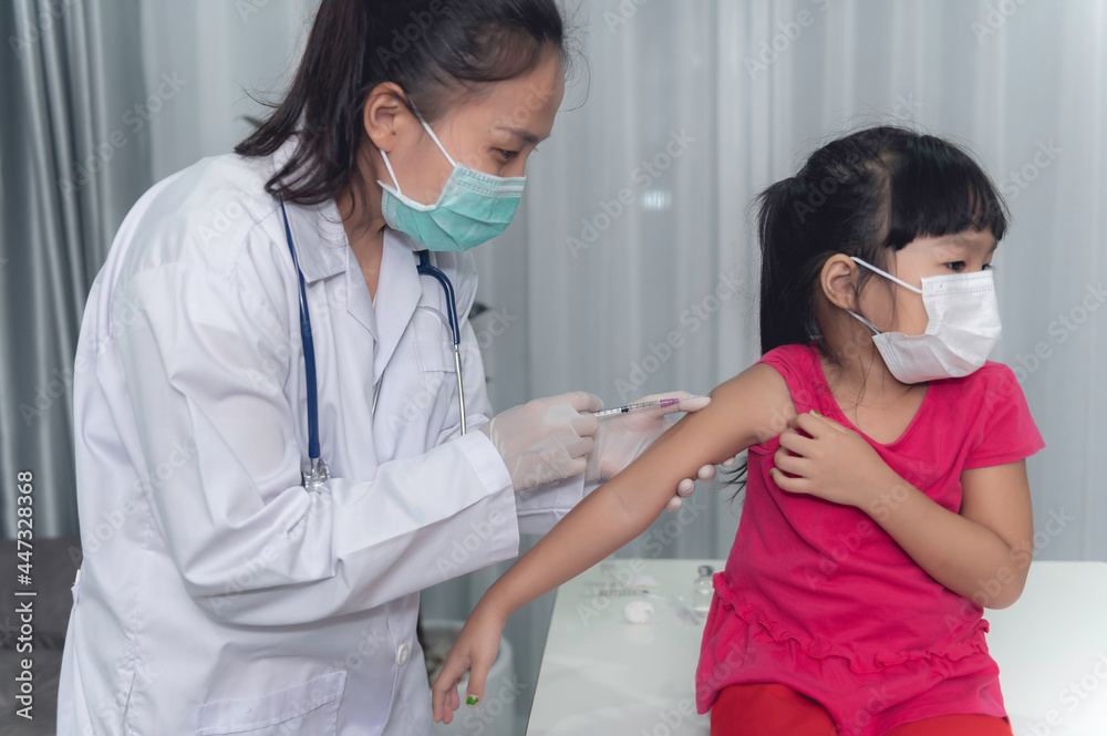 Asian doctor injection vaccine for protecting virus covid-19 to a girl wear medical mask,People are Girls are vaccinated against influenza every year. Asian doctor injection vaccine for protecting virus covid-19 to a girl wear medical mask,People are Girls are vaccinated against influenza every year.