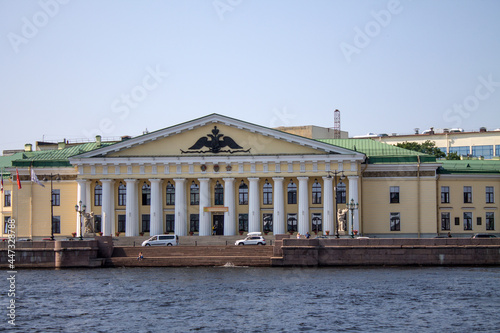 University embankment with historical architecture and the Neva River against the blue sky on a sunny summer day and copy space in Saint-Petersburg Russia
