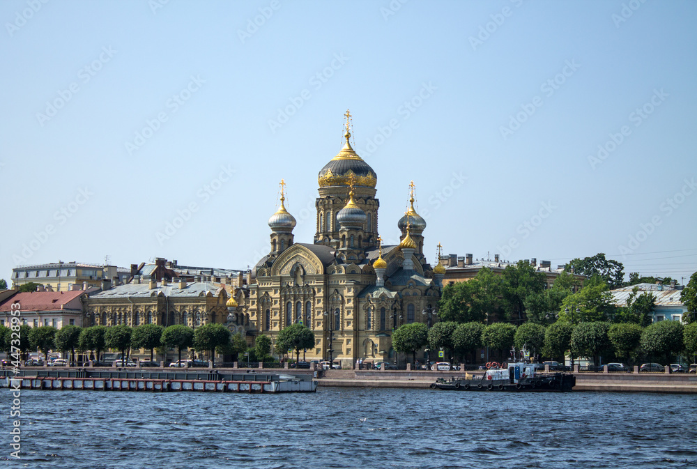 beautiful Church of the Assumption of the Blessed Virgin Mary on the Lieutenant Schmidt embankment near the Neva River on a sunny clear summer day and a copy space in Saint-Petersburg