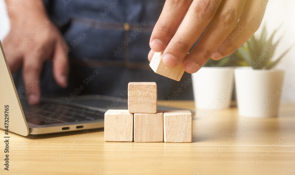 hands of businessmen, stacking wooden blocks into steps, success and business target concept, project management, company strategy development. background hands of businessmen, stacking wooden blocks into steps, success and business target concept, project management, company strategy development. background