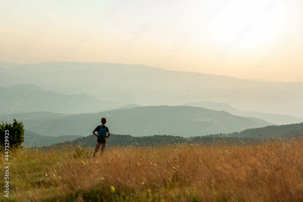 Boy hike in beautiful nature with sunset.