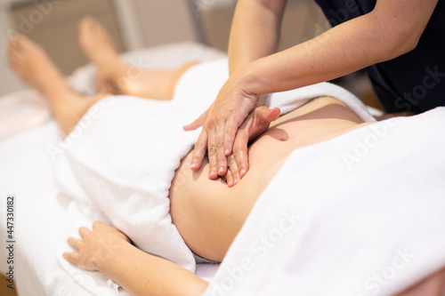 Woman receiving a belly massage in a physiotherapy center.