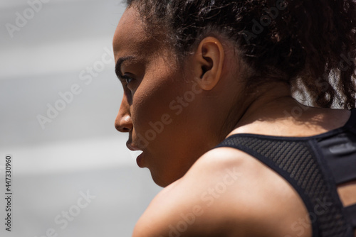 Side view of african american sportswoman looking away