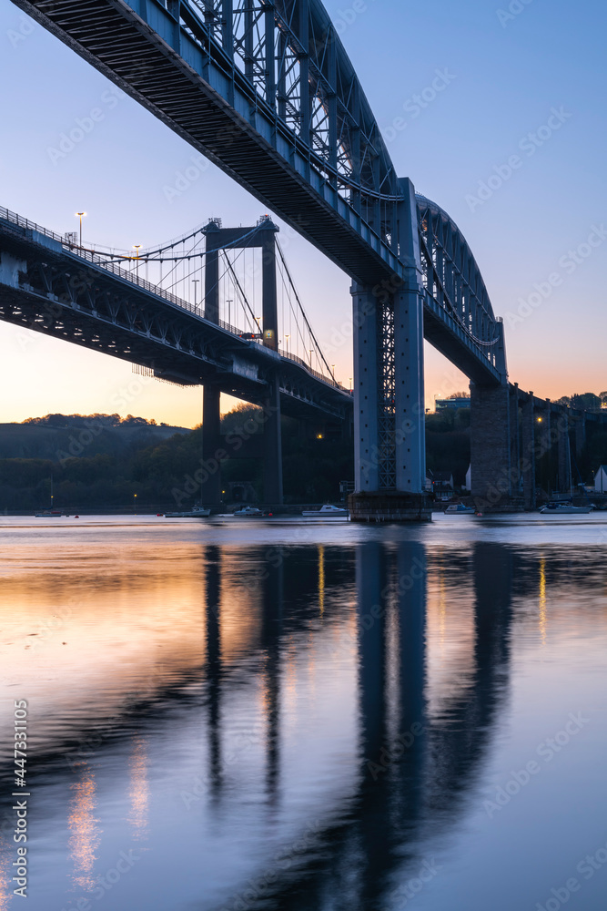 Dawn sky behind Brunel's Royal Albert Bridge and the Tamar Bridge in spring, Saltash, Cornwall, England Dawn sky behind Brunel's Royal Albert Bridge and the Tamar Bridge in spring, Saltash, Cornwall, England