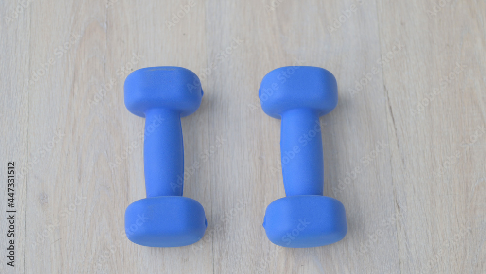 Close up shot of Blue Dumbbells on Floor Close up shot of Blue Dumbbells on Floor
