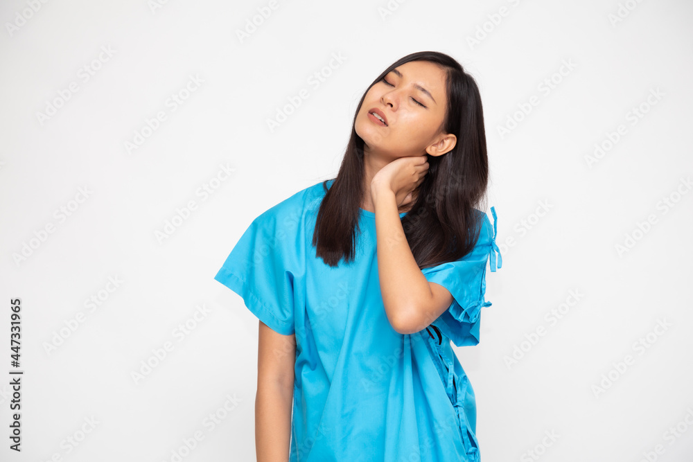 Portrait of tired young Asian woman in blue patient suit with neck pain isolated on white background Portrait of tired young Asian woman in blue patient suit with neck pain isolated on white background