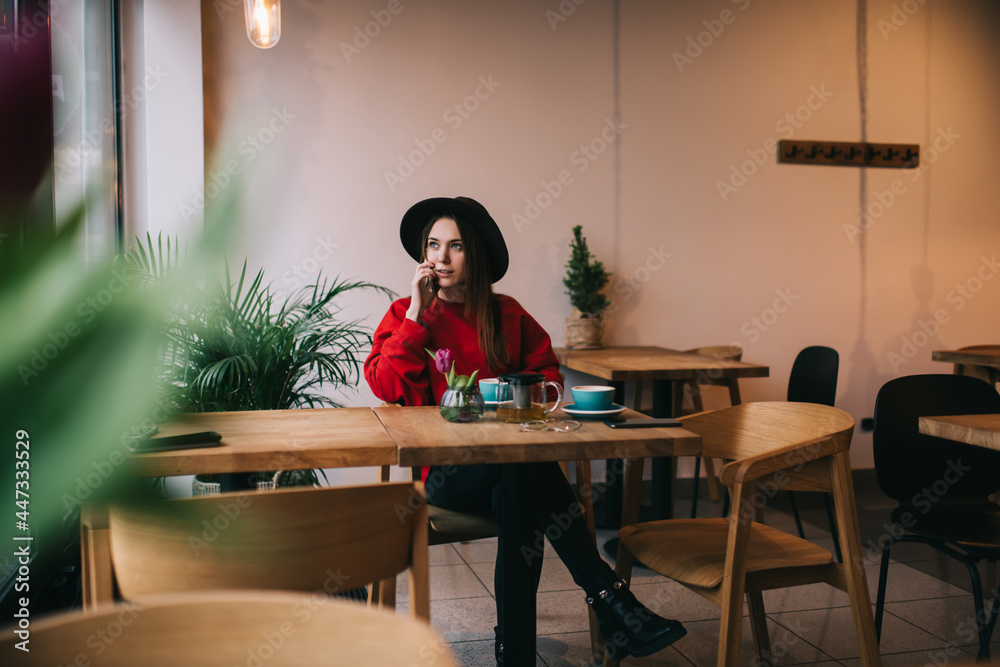 Dreamy female in stylish clothes chilling in cafe Dreamy female in stylish clothes chilling in cafe