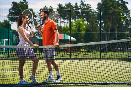Two sports players with rackets talking before the game © Viacheslav Yakobchuk