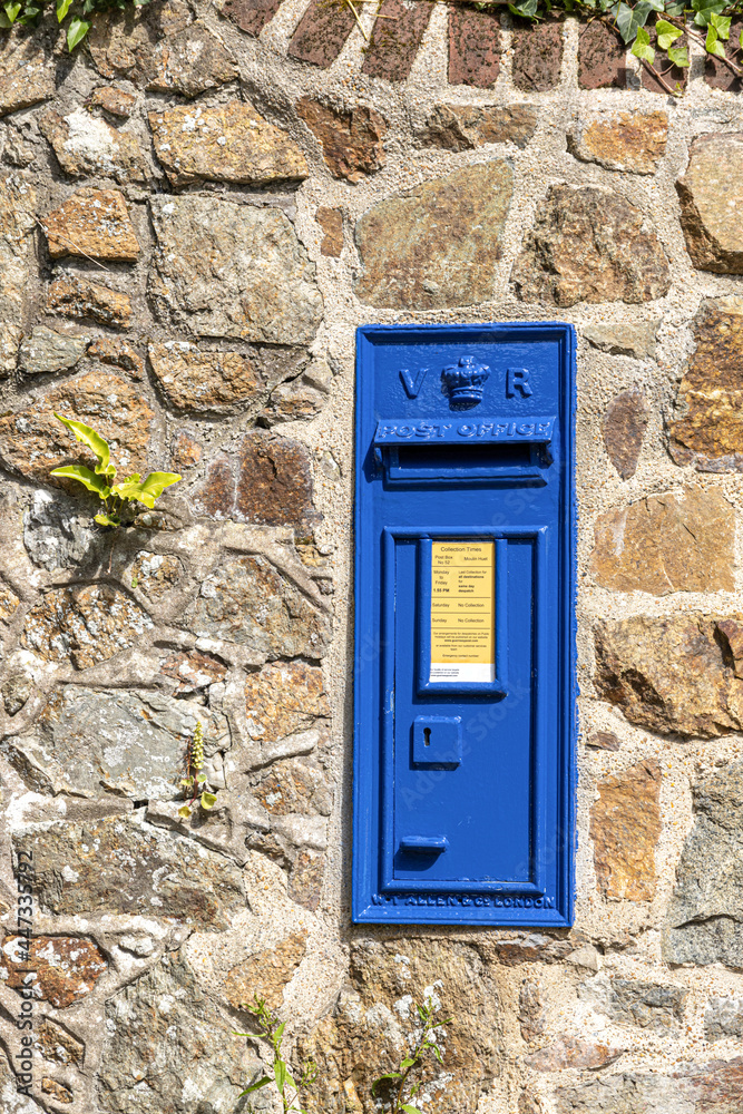 Since 1980 post boxes in Guernsey have been painted blue - This one is near Moulin Huet, Guernsey, Channel Islands UK Since 1980 post boxes in Guernsey have been painted blue - This one is near Moulin Huet, Guernsey, Channel Islands UK
