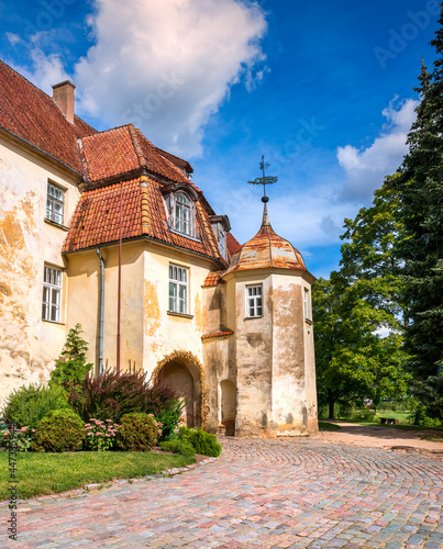 Medieval district of old European city with a public park and tower of ancien...