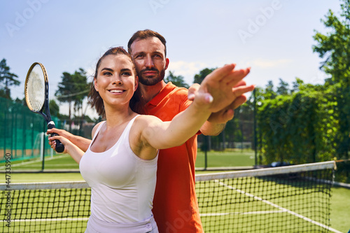 Female beginner tennis player mastering the correct hand motion © Viacheslav Yakobchuk