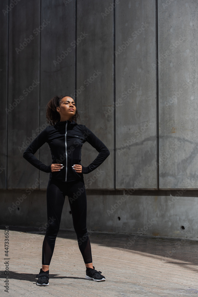 Young african american sportswoman resting on urban street Young african american sportswoman resting on urban street