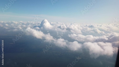 Aerial view from window of flying airplane. Beautiful cloudy sky. Gorgeous skyscape or cloudscape. Concept of heaven and tranquility.