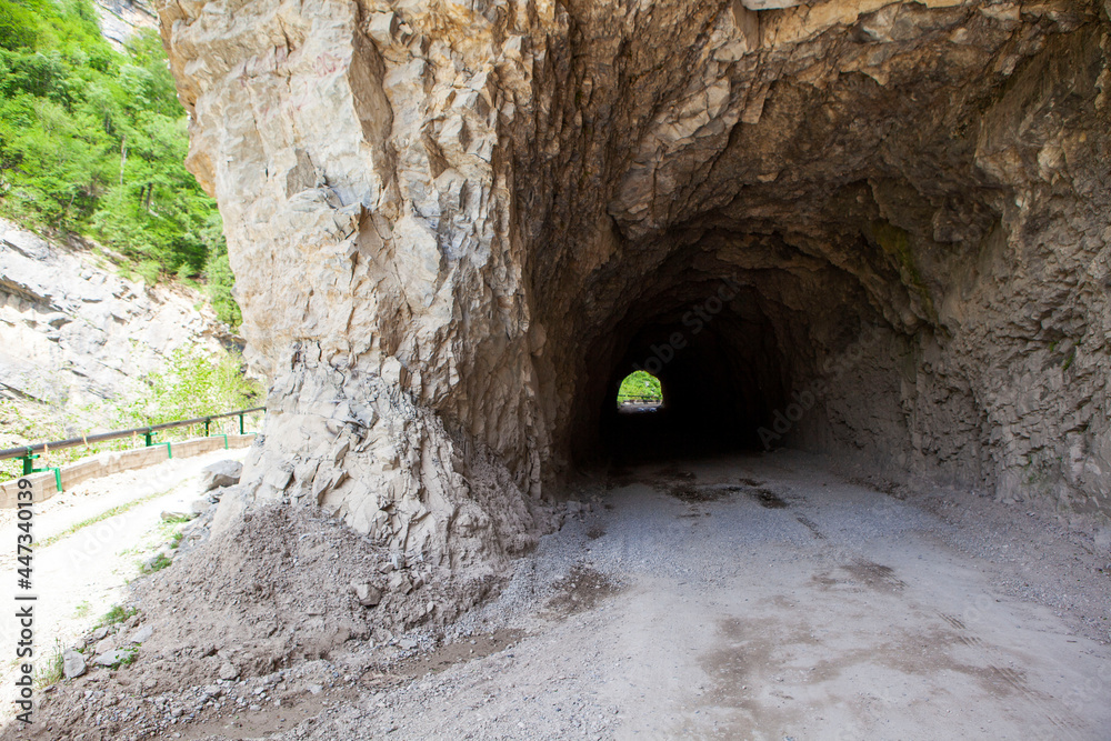 Obraz premium A tunnel made in the mountain and an old road around the mountain. Digorskoe gorge. North Ossetia. Russia.