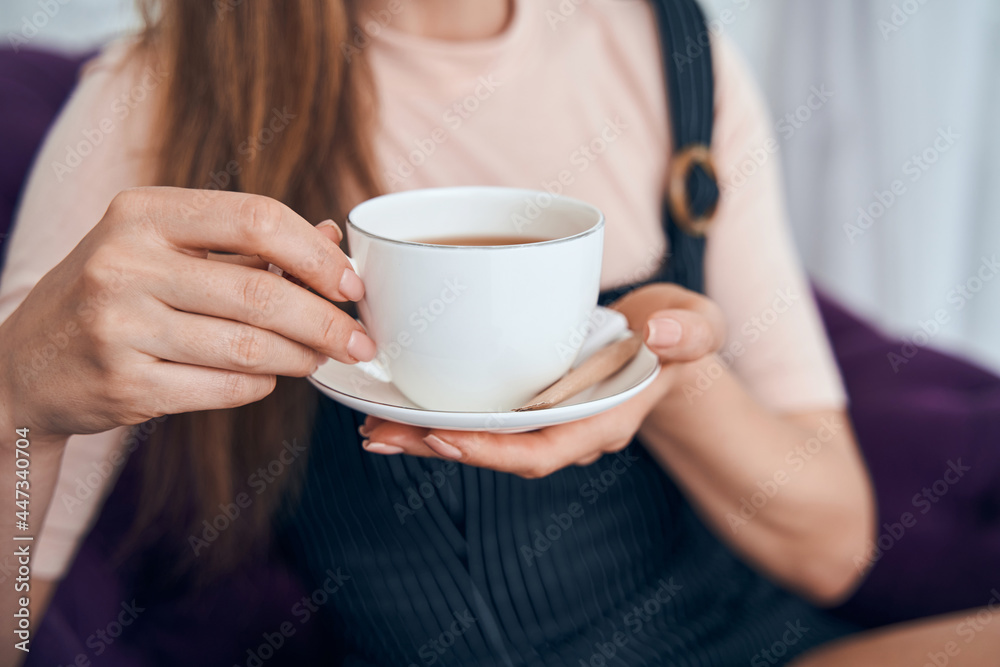 Close up of female hand holding cup Close up of female hand holding cup