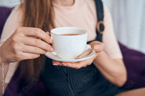 Close up of female hand holding cup