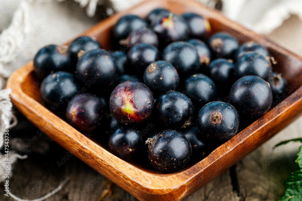Fresh black currant. A handful of berries on a wooden table Fresh black currant. A handful of berries on a wooden table