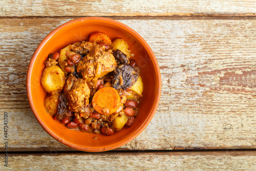 Jewish dish chelnt with meat on a wooden table in a plate. copy space photo